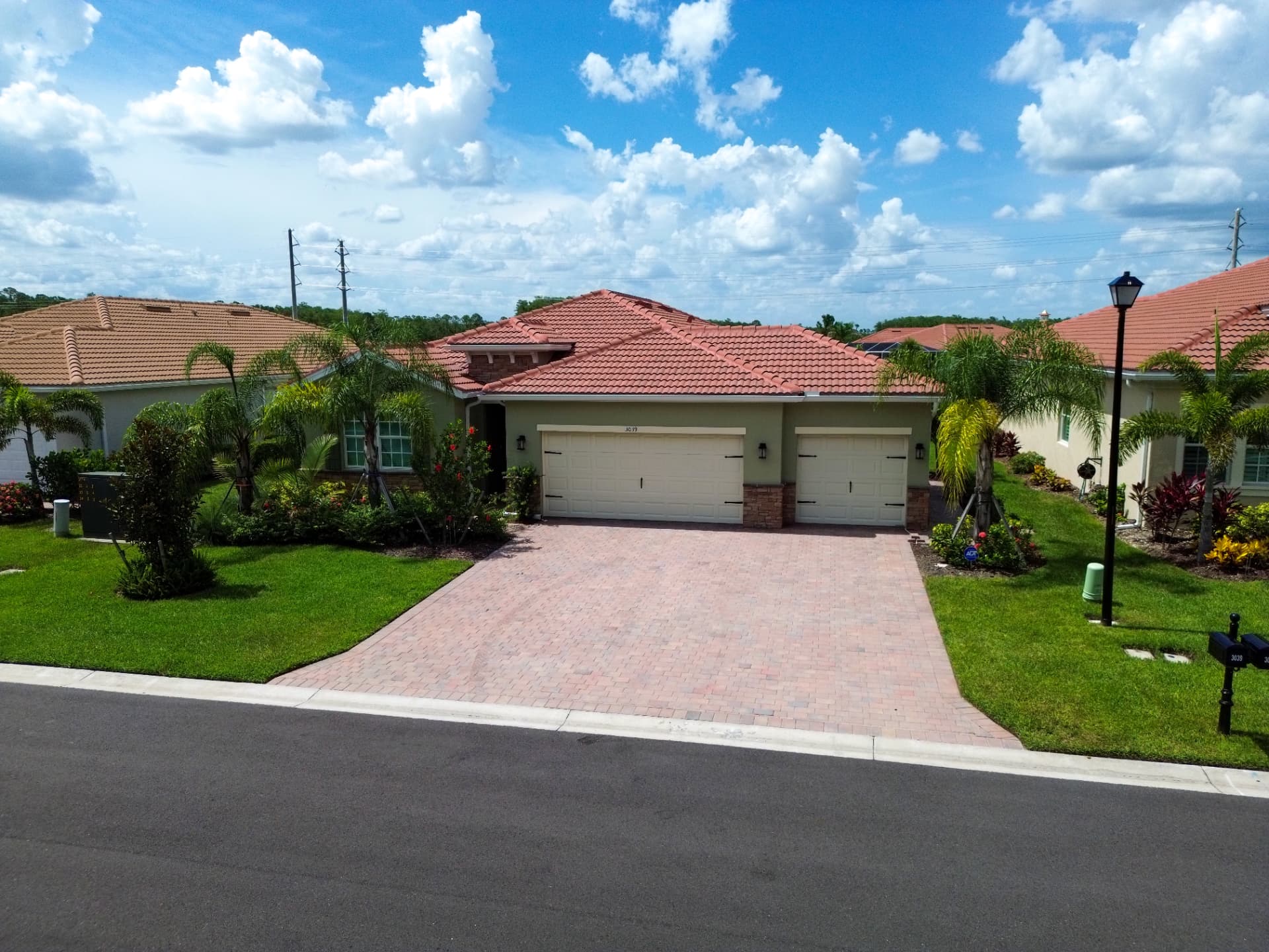 Aerial photo of a single-family home showing roofline, driveway and lot